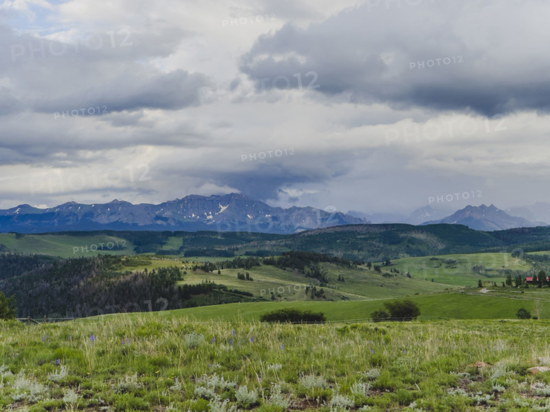 Clouds above grassy meadow and San Juan Mountains
Telluride, Colorado, USA