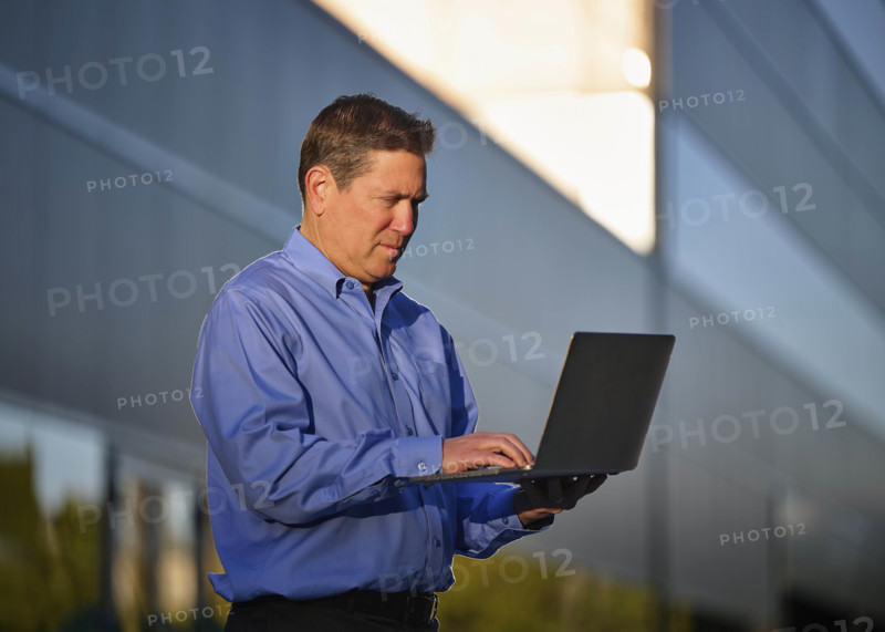 Man working on laptop outdoors