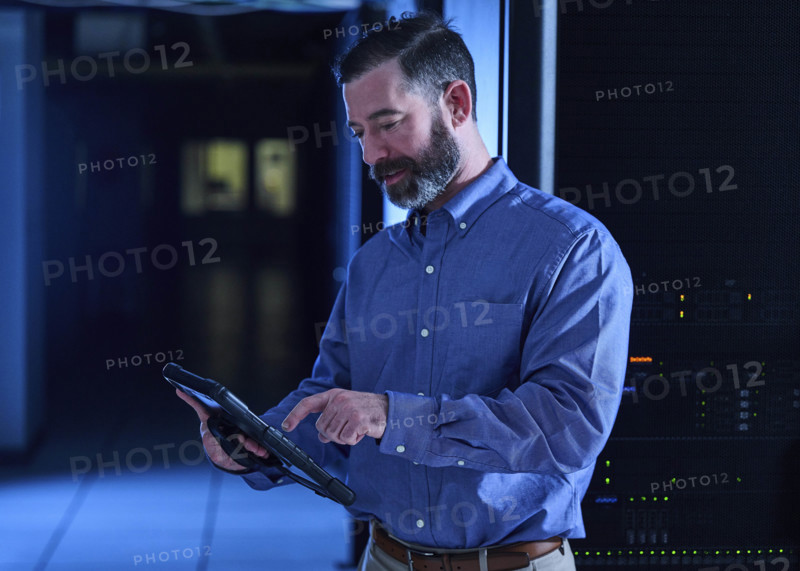 Man using tablet in data center