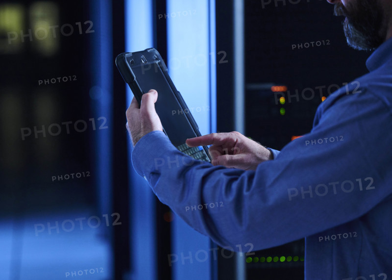 Close-up of man using tablet in data center