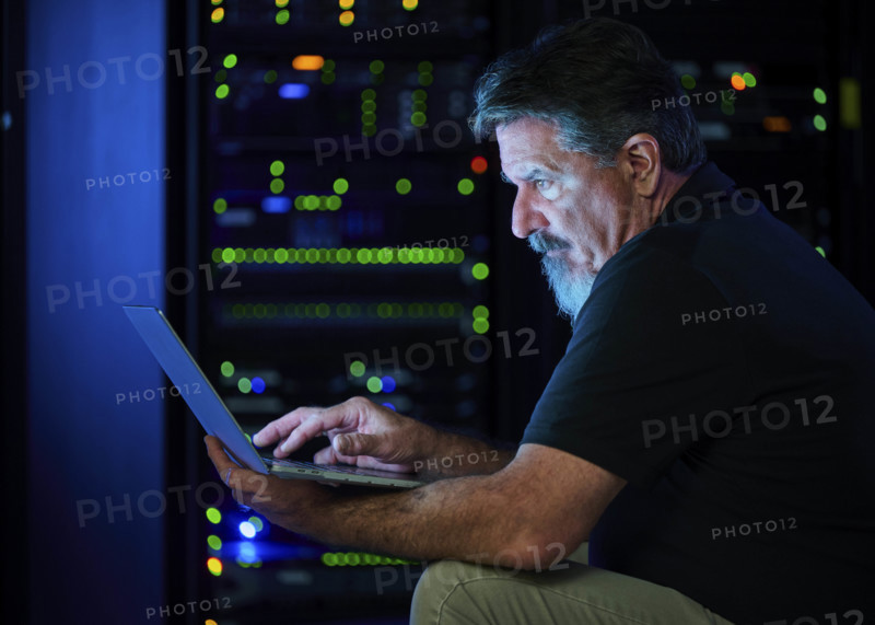 Man using laptop in data center
