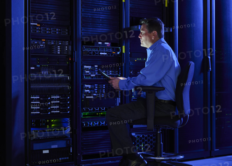 Man using digital tablet in data center