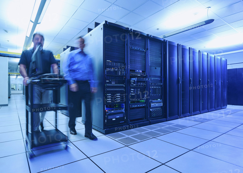 Two men walking in data center