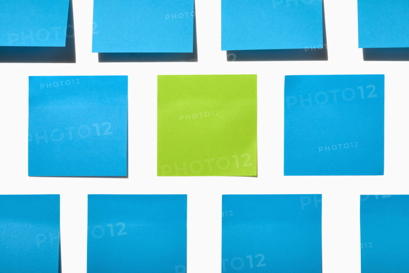 Blue and green post it notes on white background