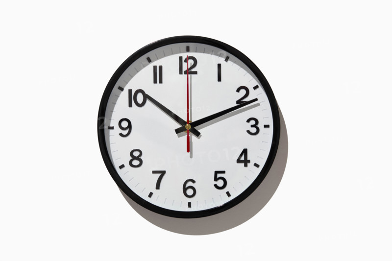 Studio shot of analog wall clock on white background