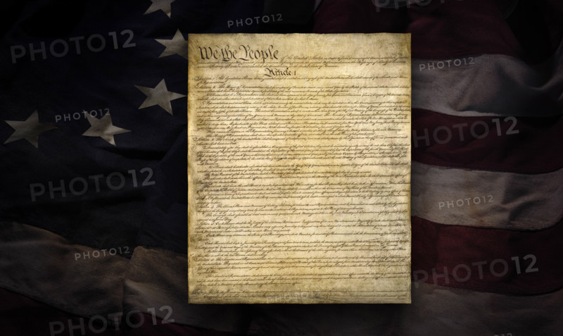 American Constitution superimposed over early thirteen star flag