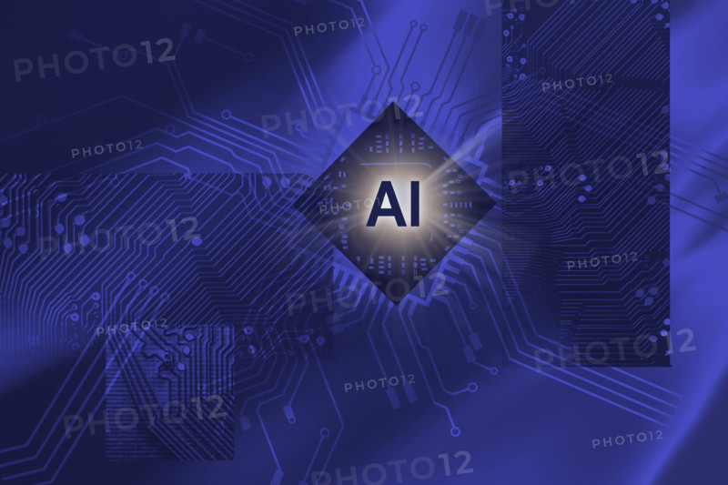 AI symbol against electronic background of computer parts and circuits