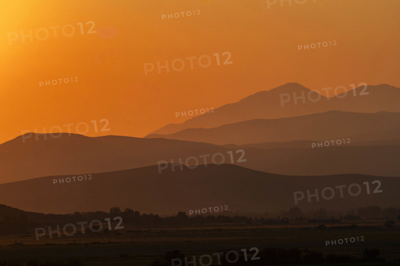 USA, Idaho, Bellevue, Silhouettes of hills against orange sky at sunset
