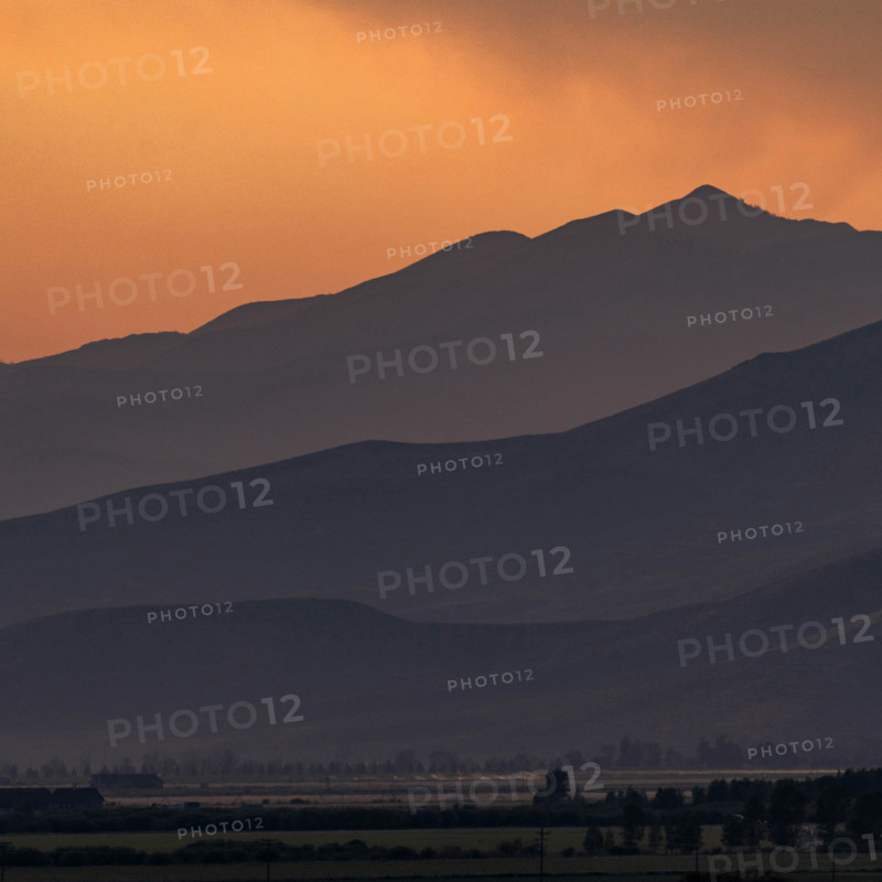 USA, Idaho, Bellevue, Silhouettes of hills against orange sky at sunset
