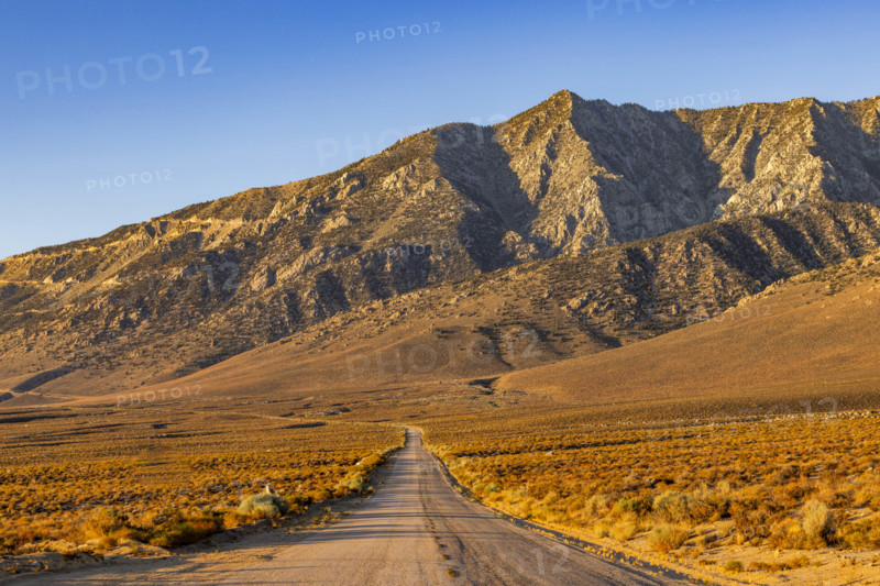 USA, California, Lone Pine, Dirt road leading to barren mountains