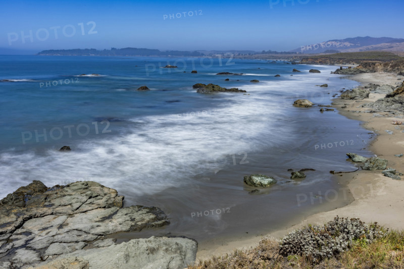USA, California, San Simeon, Ocean waves washing sandy beach, long exposure