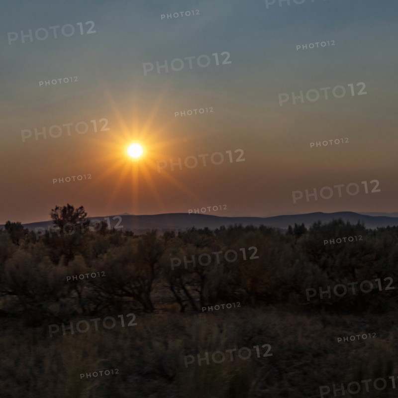USA, Idaho, Twin Falls, Sun setting above desert landscape