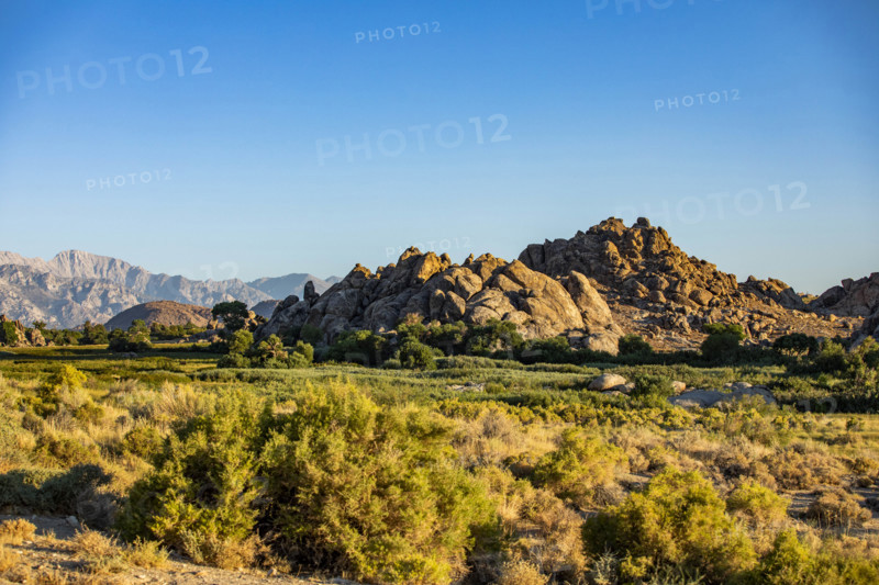 USA, California, Lone Pine, Rock formations and bushes on sunny day
