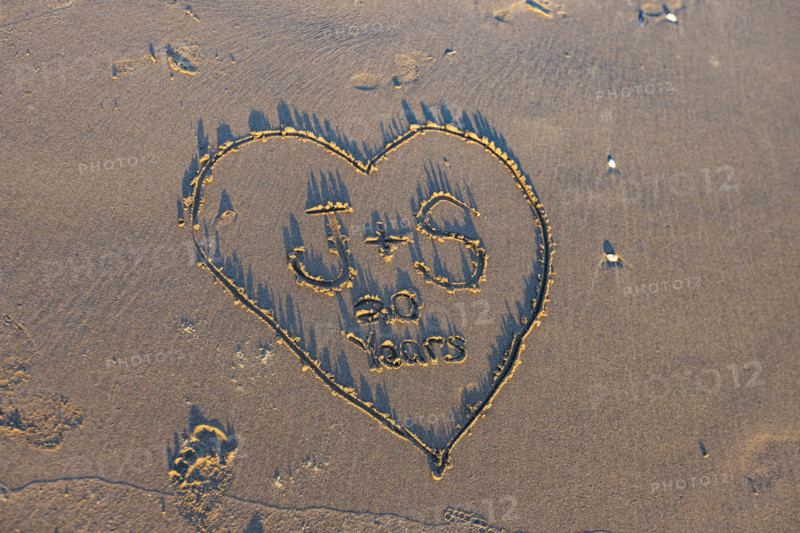 Heart with message in sand