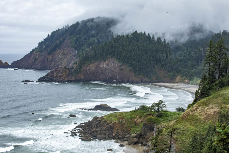 USA, Oregon, Cannon Beach, Clouds and fog over Indian Beach and headland