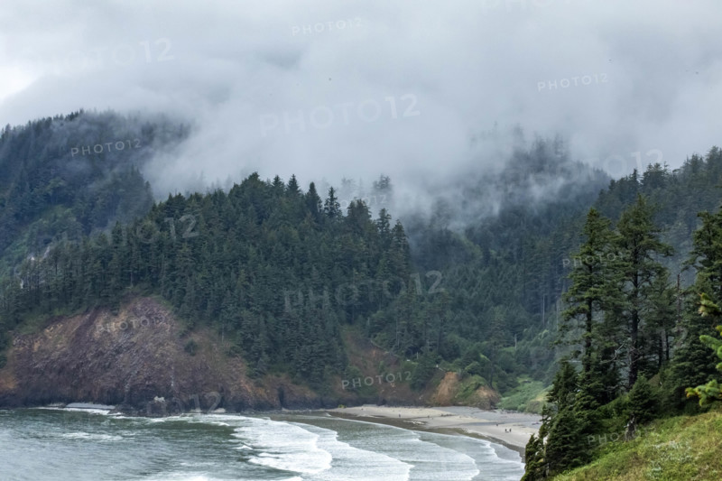 USA, Oregon, Cannon Beach, Clouds and fog over Indian Beach and headland