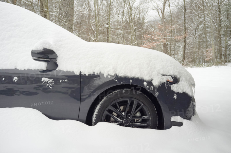 Car covered with fresh deep snow