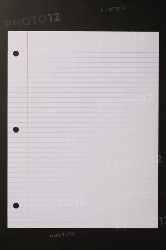 Blank lined paper on black background