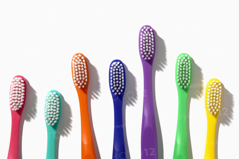 Colorful toothbrushes on white background
