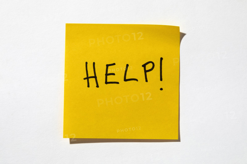 Help written on yellow post it note
