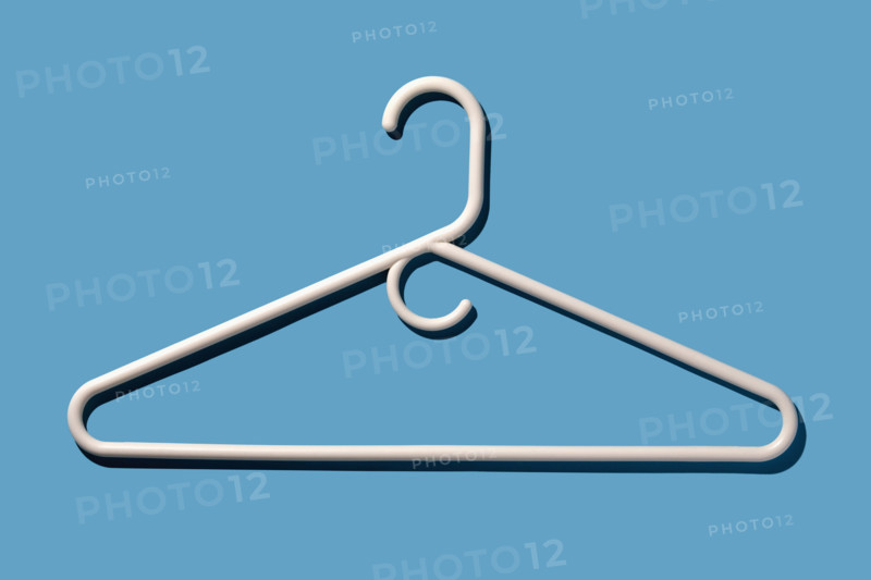 White coat hanger on blue background