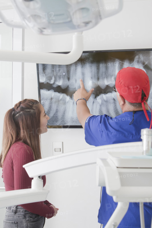 Dentist explaining X-ray to female patient