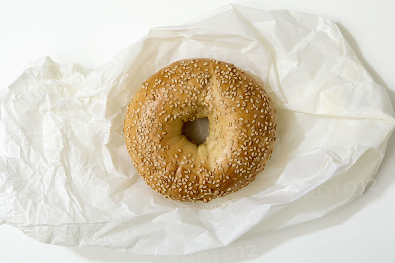 Overhead view of bagel on white background