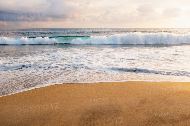 Mexico, Oaxaca State, Puerto Escondido, Costa Chica, Clouds over ocean waves on empty beach