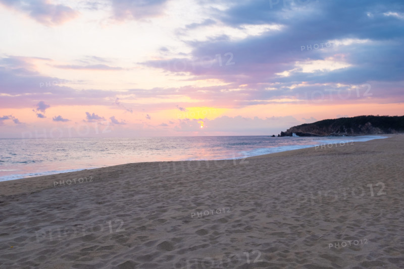 Mexico, Oaxaca State, Puerto Escondido, Costa Chica, Sun setting over ocean and empty beach