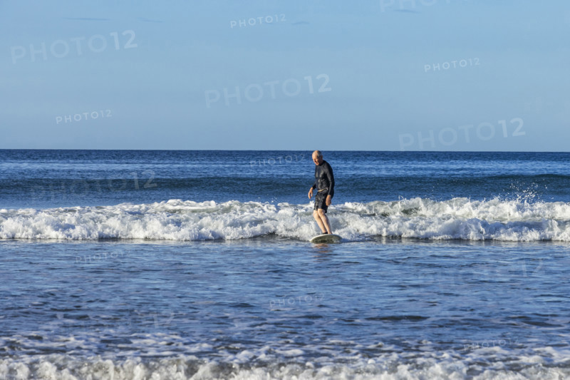 Costa Rica, Guanacaste, Playa Grande, Senior man surfing on sea wave