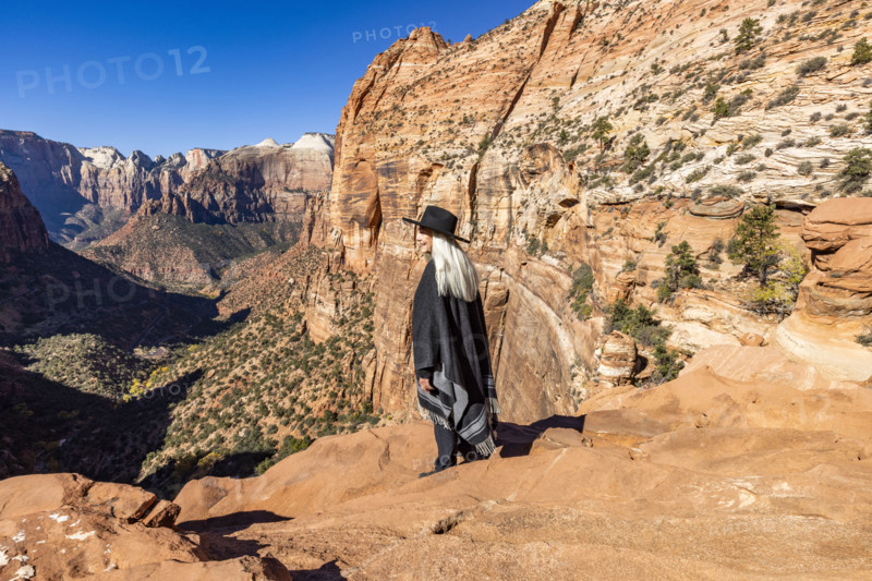USA, Utah, Zion National Park, Smiling woman in poncho and hat at Zion Canyon Overlook