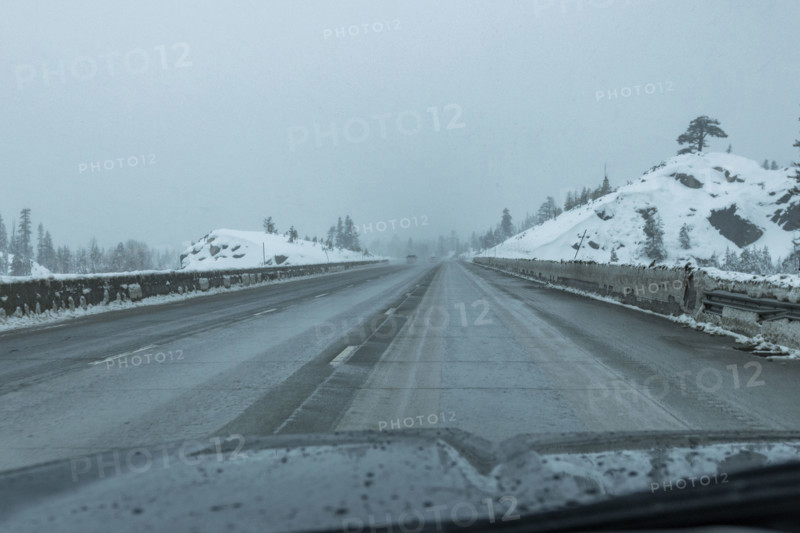 USA, California, Donner Pass, Empty highway seen from car during rain in winter