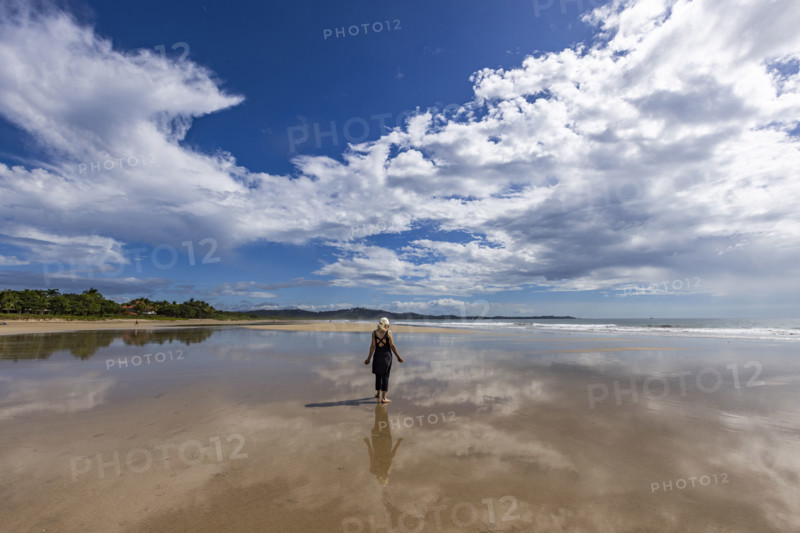 Costa Rica, Guanacaste, Playa Grande, Woman standing on empty beach