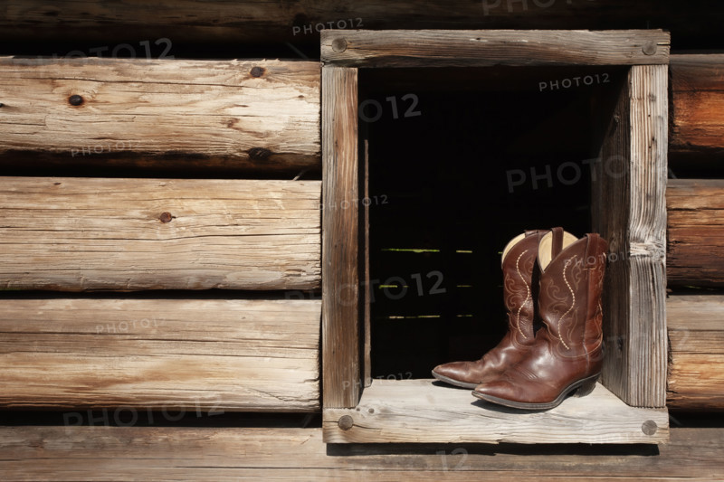 Cowboy boots in cabin window