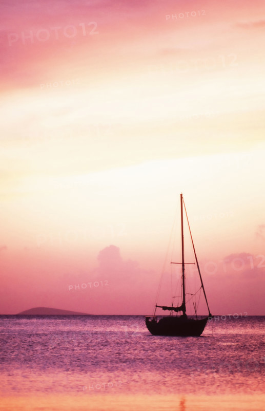 USA, United States Virgin Islands, St. Thomas, Silhouette of sailboat on Pillsbury Sound at sunrise