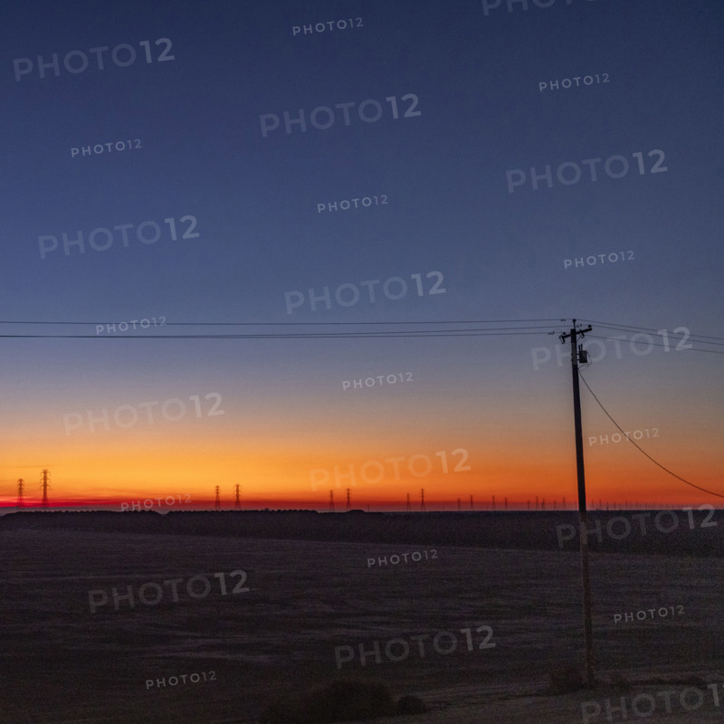 USA, California, Kettleman City, Telephone pole in field at sunrise