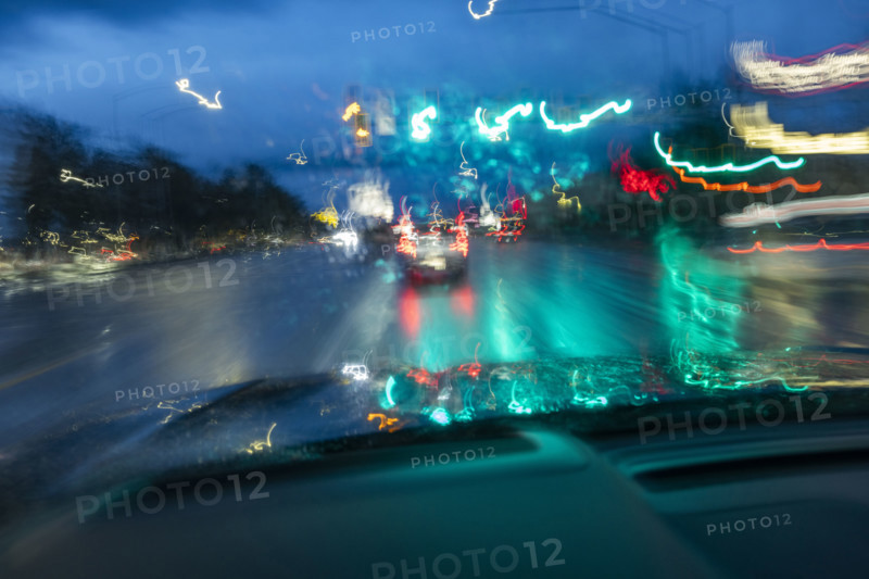 Traffic on road in rain at dusk seen from carmotion blur