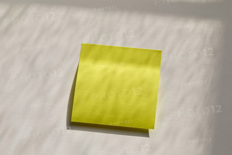 Blank yellow post it note on wall. New York City, New York State, USA.