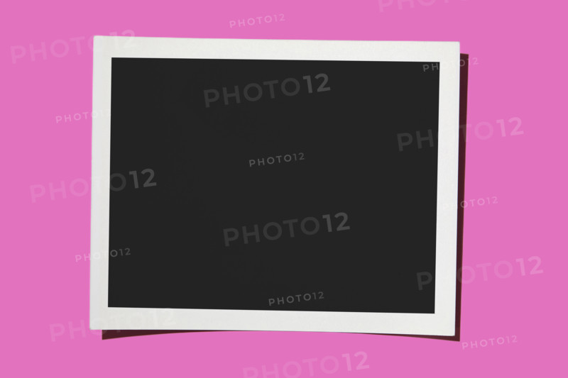 Blank Polaroid on pink background. New York City, New York State, USA.