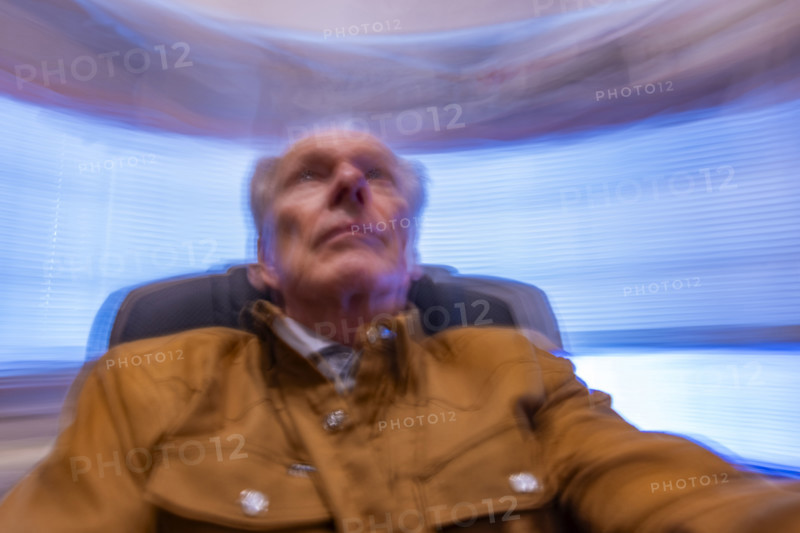 Senior man in desk chair, motion blurred. Bellevue, Idaho, USA.