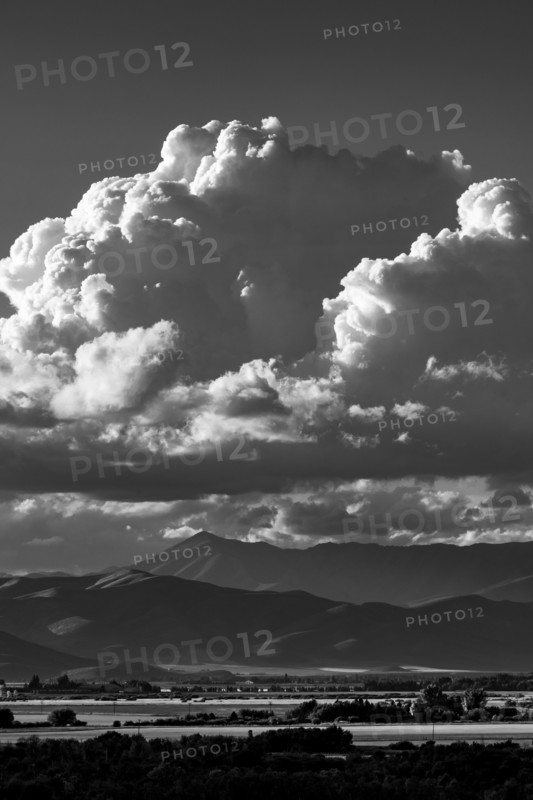 White puffy clouds over mountains, black and white. Bellevue, Idaho, USA.
