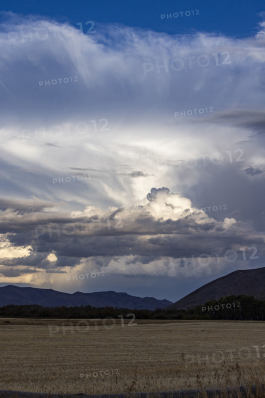 Storm clouds over field. Bellevue, Idaho, USA.