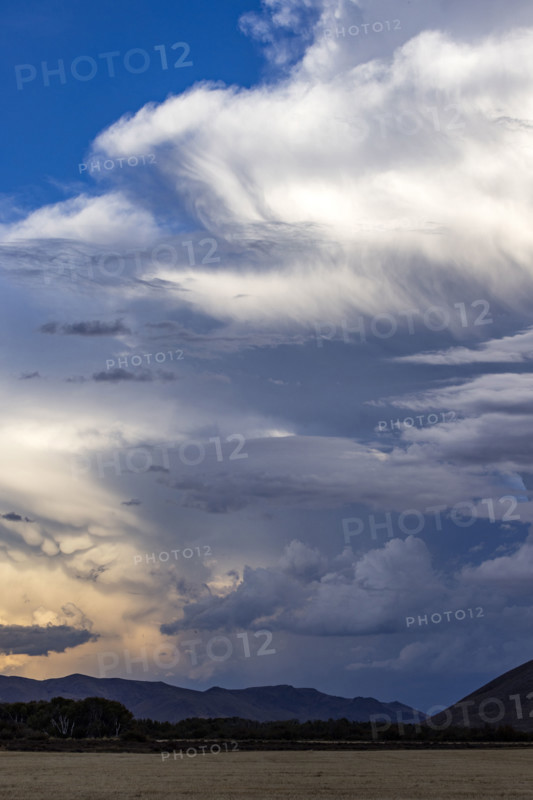 Dramatic clouds over mountains and field. Bellevue, Idaho, USA.