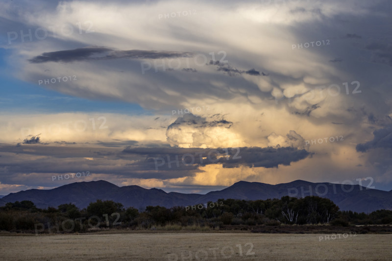 Dramatic clouds over mountains and field. Bellevue, Idaho, USA.