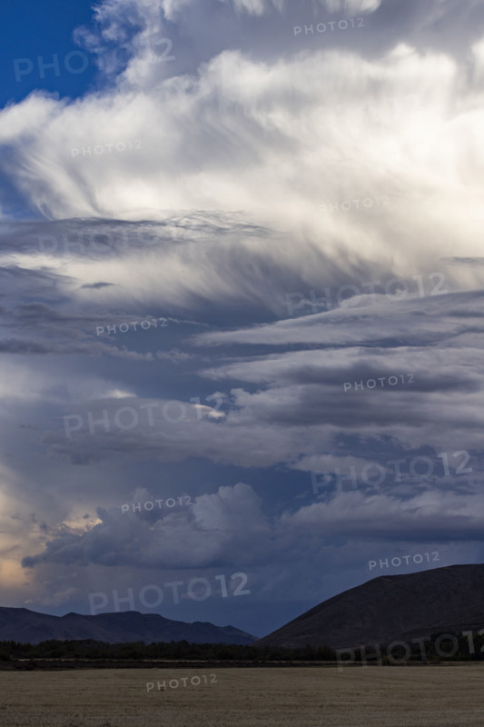 Dramatic clouds over mountains and field. Bellevue, Idaho, USA.