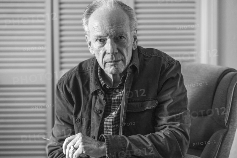 Portrait of senior man sitting in armchair, black and white. Boise, Idaho, USA.