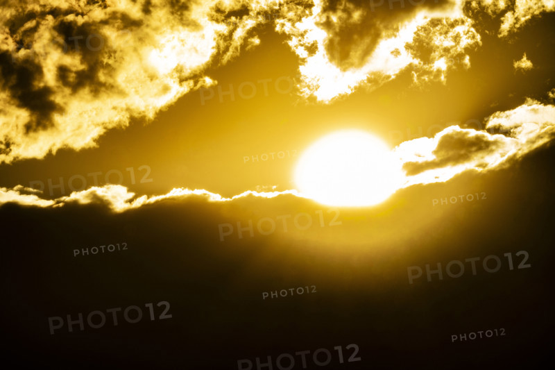 Golden sun setting behind clouds. Bellevue, Idaho, USA.