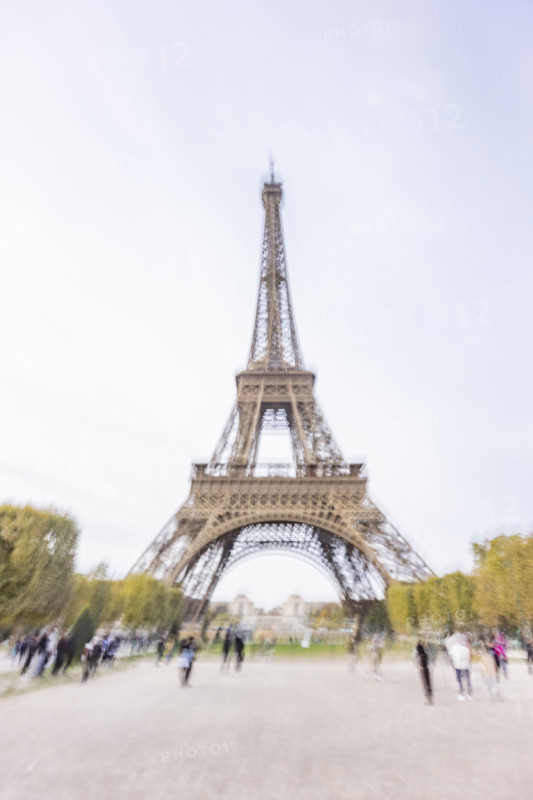 Tourists near Eiffel Tower, blurred motion. Paris, Ile de France, France.