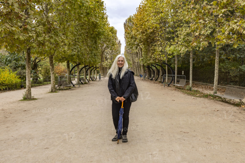 Portrait of smiling woman in Jardin des Plantes. Paris, Ile de France, France.