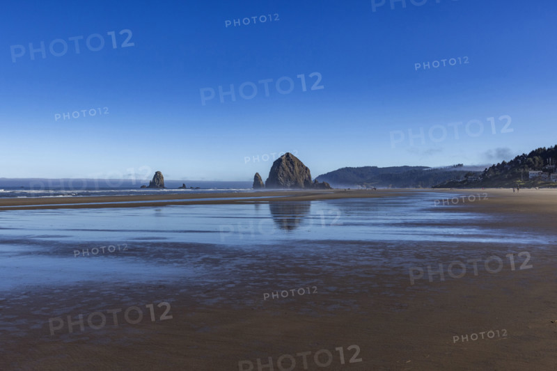Cannon Beach at low tide with Haystack Rock in background. , Oregon, USA.